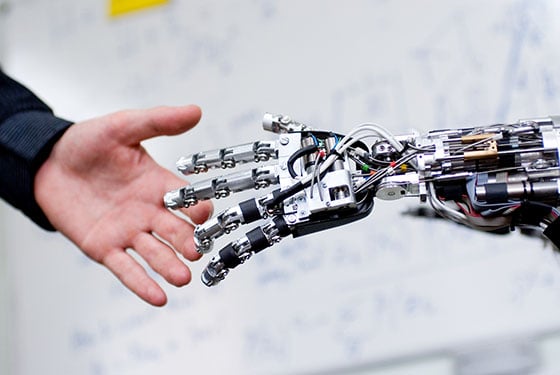 Robot hand shaking a Human hand